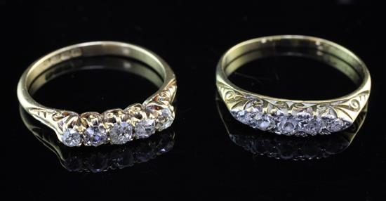 Two early 20th century 18ct gold and five stone half hoop diamond rings, sizes Q & S.